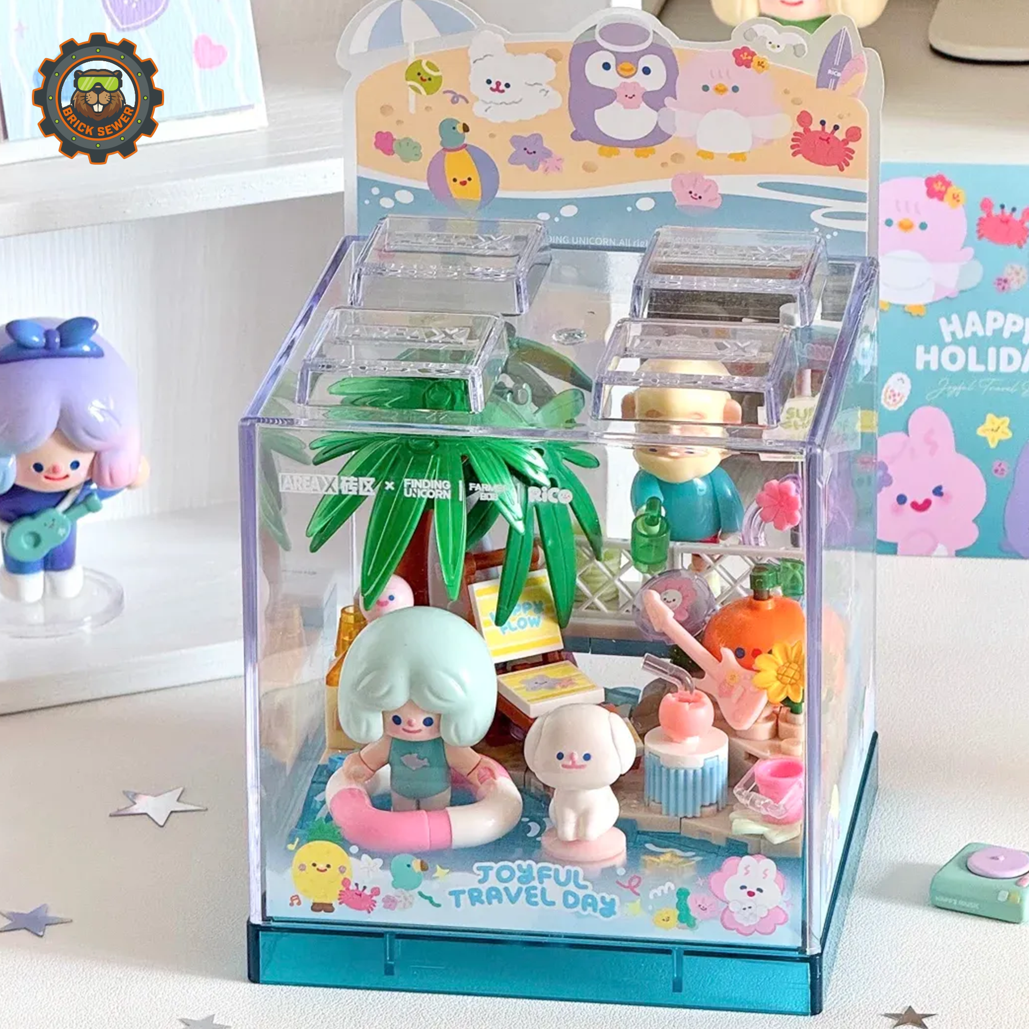 Rico & Bob - Travel Day display with figures enjoying a beach vacation inside a clear cube.